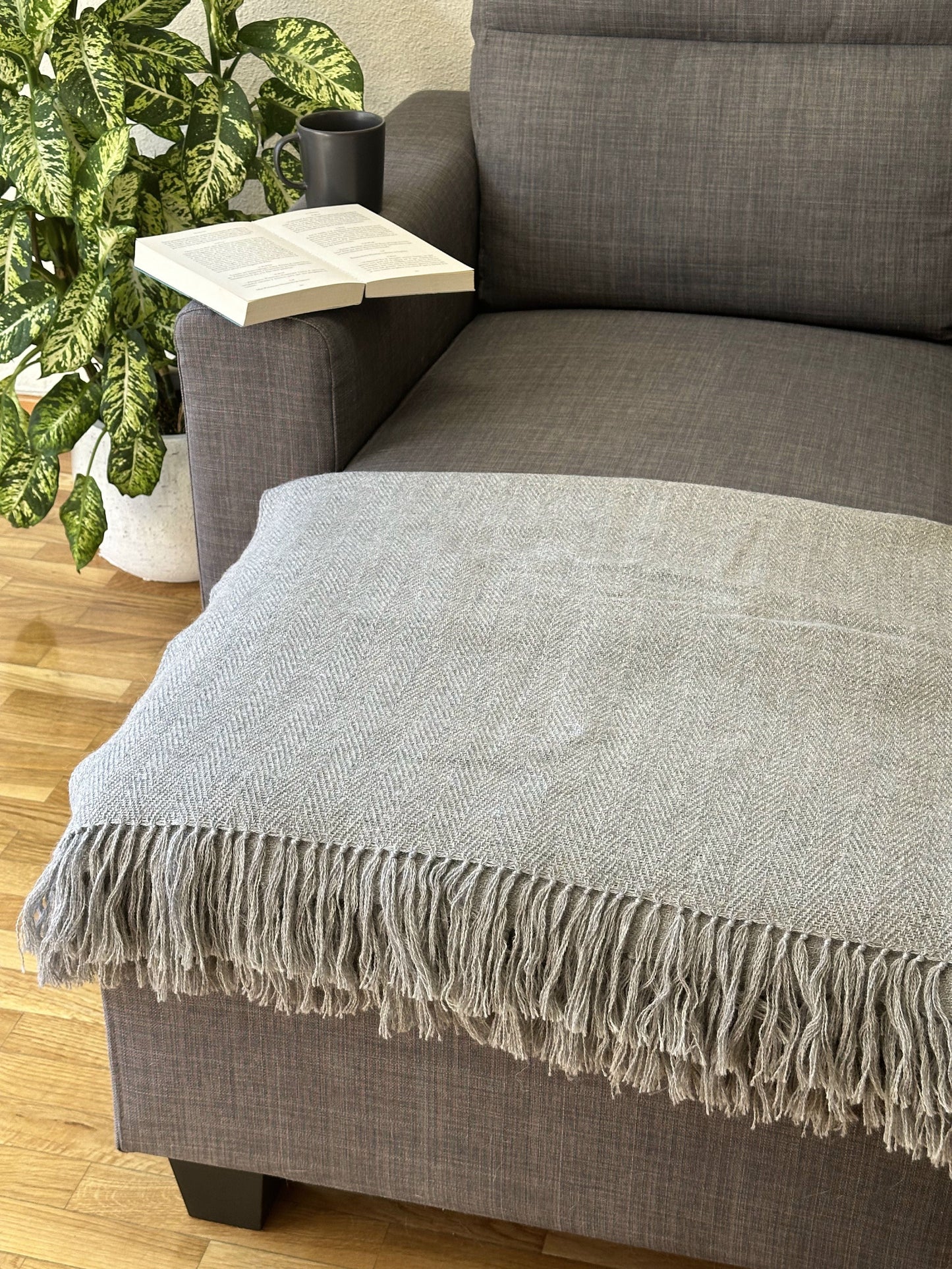 Hand-knitted solid grey baby alpaca blanket. Measures 180 cm in length by 130 cm in width.